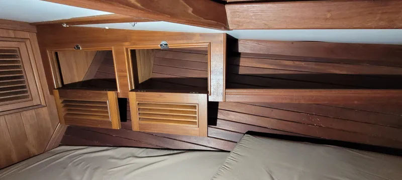 Slide: The Image of Interior of 1980 Shannon 38 Ketch with wooden cabinetry and bed. - 13