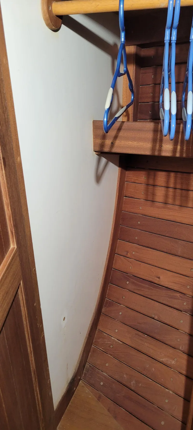 Slide: The Image of Wooden interior of 1980 Shannon 38 Ketch with hangers in closet. - 16