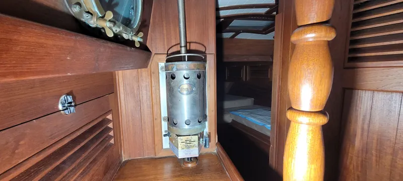 Slide: The Image of Interior of 1980 Shannon 38 Ketch, showcasing wooden paneling and vintage marine equipment. - 17