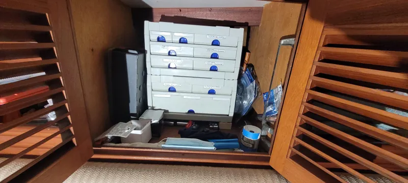 Slide: The Image of Storage compartment on 1980 Shannon 38 Ketch with organized drawers and tools. - 19