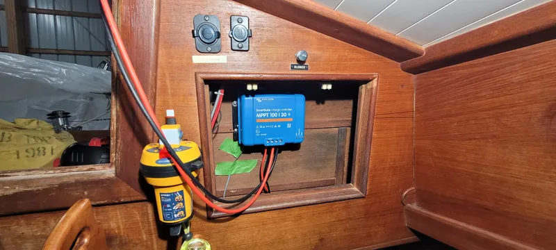 Slide: The Image of Electrical panel inside a 1980 Shannon 38 Ketch sailboat, featuring wiring and a blue controller. - 23