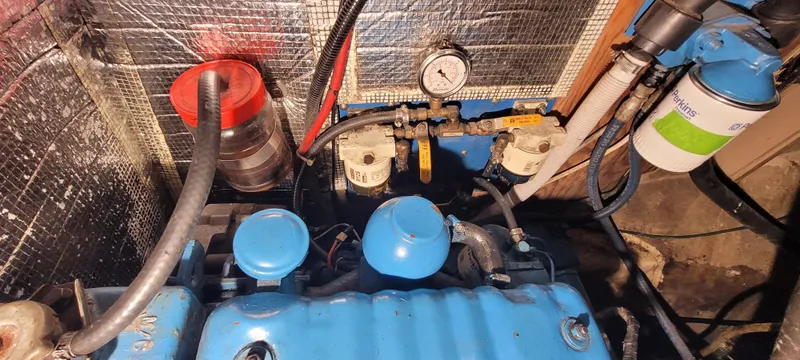 Slide: The Image of Engine compartment of a 1980 Shannon 38 Ketch, featuring blue components and fuel filters. - 31
