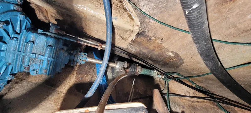 Slide: The Image of Engine compartment of a 1980 Shannon 38 Ketch with visible blue machinery and hoses. - 32