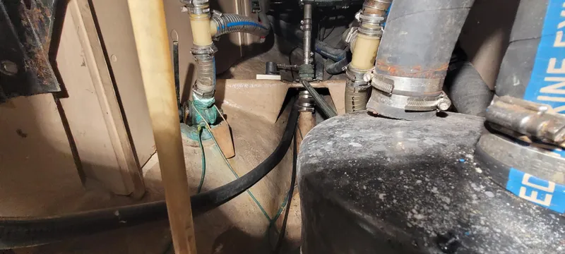 Slide: The Image of Engine compartment of a 1980 Shannon 38 Ketch, showing hoses and mechanical components. - 33