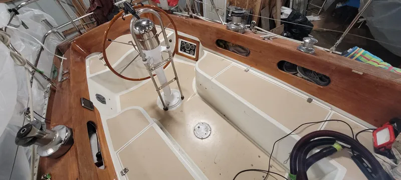 Slide: The Image of 1980 Shannon 38 Ketch sailboat cockpit with wooden accents and steering wheel. - 39