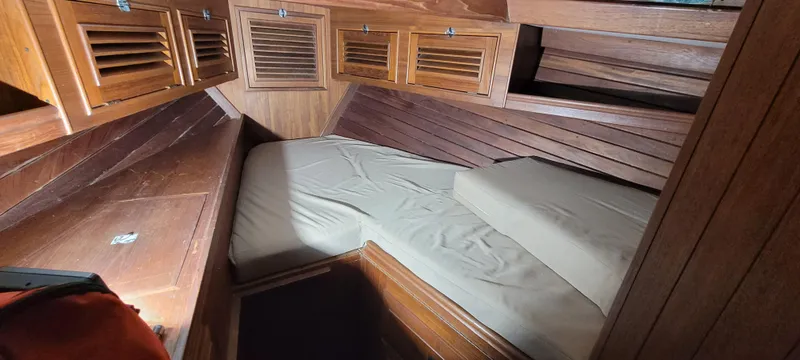 Slide: The Image of Cozy cabin interior of 1980 Shannon 38 Ketch with wooden finish and storage cabinets. - 4