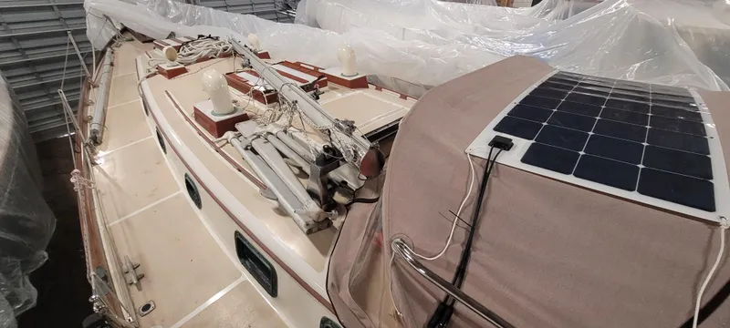 Slide: The Image of 1980 Shannon 38 Ketch sailboat with solar panel, docked indoors. - 42