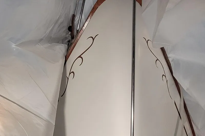 Slide: The Image of 1980 Shannon 38 Ketch sailboat with decorative design, partially covered. - 49