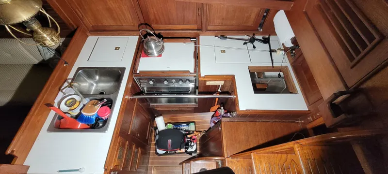 Slide: The Image of Interior view of 1980 Shannon 38 Ketch galley with wooden cabinetry and stainless steel sink. - 6