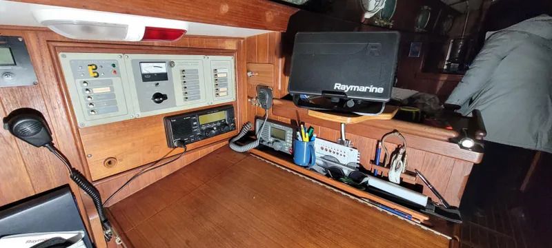 Slide: The Image of Navigation station on a 1980 Shannon 38 Ketch with Raymarine equipment and communication tools. - 8