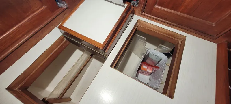 Slide: The Image of Storage compartments in 1980 Shannon 38 Ketch yacht interior with wooden cabinetry. - 9