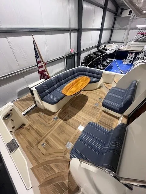 Slide: The Image of 2011 Sabre 40 Sedan yacht interior with striped seating and wooden table. - 11