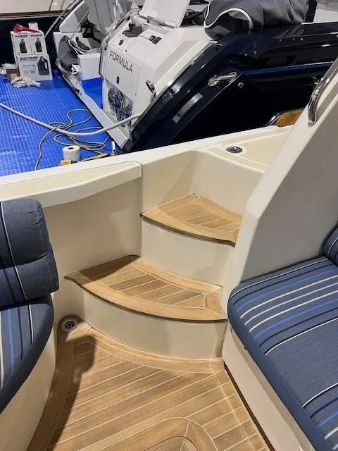 Slide: The Image of 2011 Sabre 40 Sedan interior with wooden steps and blue seating. - 12
