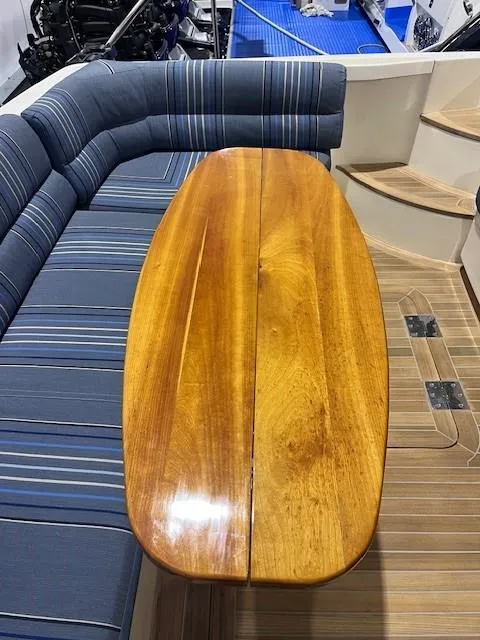 Slide: The Image of 2011 Sabre 40 Sedan interior with wooden table and striped seating. - 13