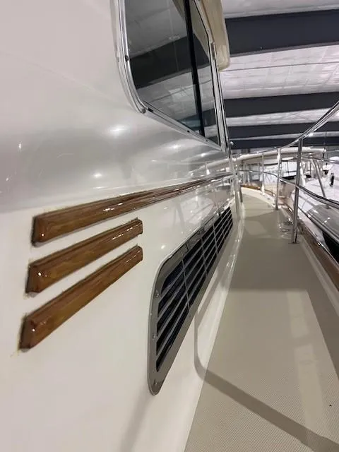 Slide: The Image of 2011 Sabre 40 Sedan yacht, side view with sleek design and wooden accents. - 14