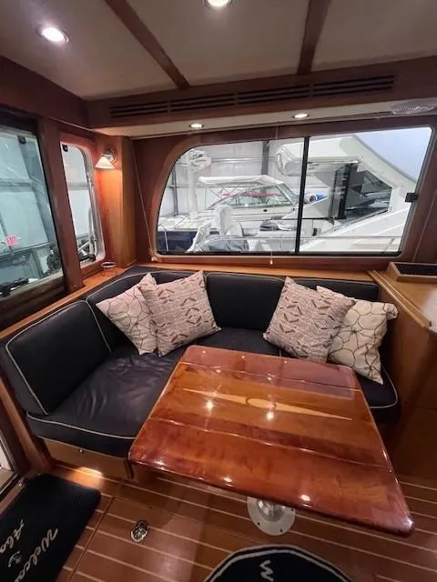 Slide: The Image of Luxurious interior of a 2011 Sabre 40 Sedan yacht with elegant seating and wooden table. - 21