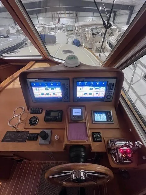Slide: The Image of 2011 Sabre 40 Sedan helm with dual navigation screens and control panel. - 26