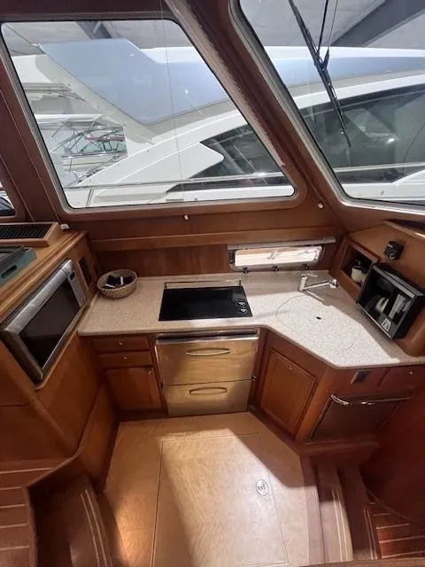 Slide: The Image of 2011 Sabre 40 Sedan yacht interior with modern kitchen and wooden cabinetry. - 31