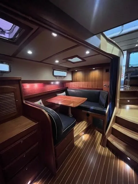 Slide: The Image of 2011 Sabre 40 Sedan interior with elegant wood finish and cozy seating area. - 36