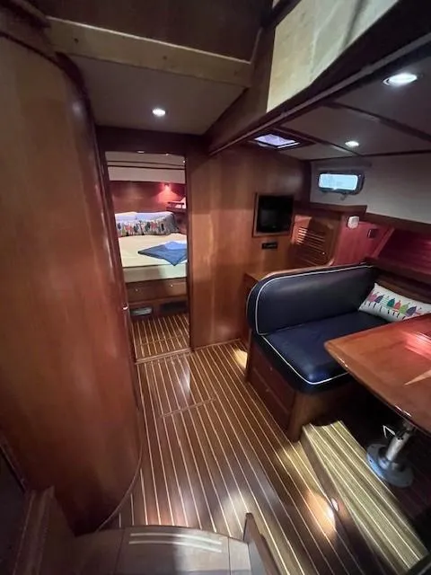 Slide: The Image of 2011 Sabre 40 Sedan interior with wood finish, seating area, and cozy cabin. - 37