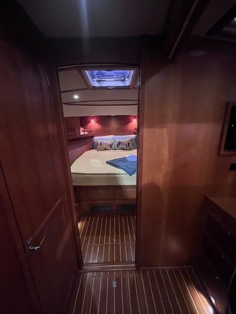 Slide: The Image of 2011 Sabre 40 Sedan cabin interior with wood finish and cozy bed. - 38