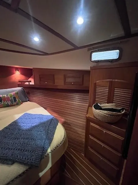 Slide: The Image of 2011 Sabre 40 Sedan cabin interior with cozy bed and wooden storage. - 41