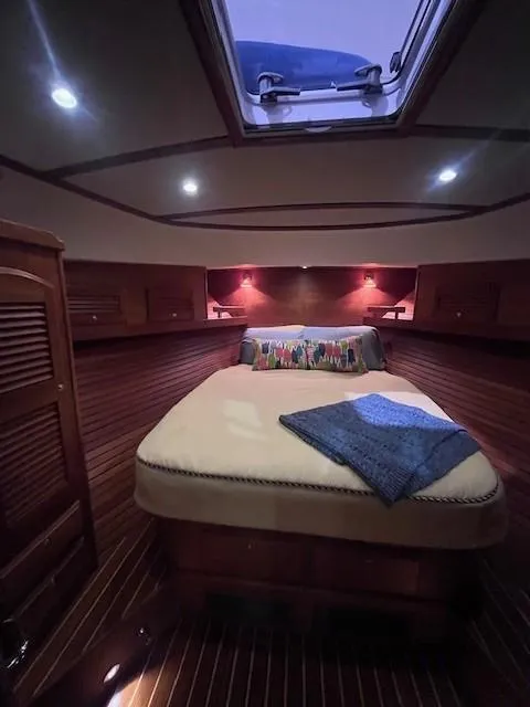 Slide: The Image of Luxurious cabin interior of 2011 Sabre 40 Sedan yacht with skylight and cozy bedding. - 42