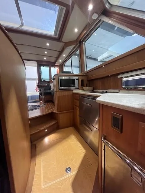 Slide: The Image of Interior of 2011 Sabre 40 Sedan yacht with modern kitchen and wood finishes. - 46