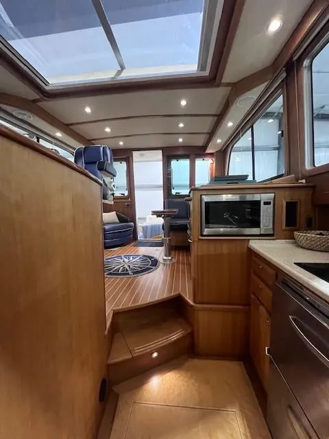 Slide: The Image of Interior of a 2011 Sabre 40 Sedan yacht, featuring a modern kitchen and seating area. - 47