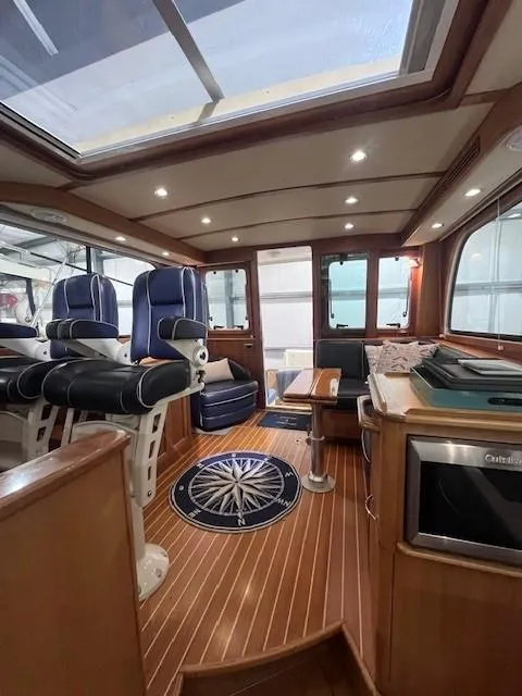Slide: The Image of Interior of a 2011 Sabre 40 Sedan yacht with luxurious seating and wood flooring. - 48