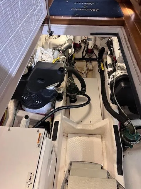 Slide: The Image of Engine room of a 2011 Sabre 40 Sedan boat, showcasing mechanical components. - 49