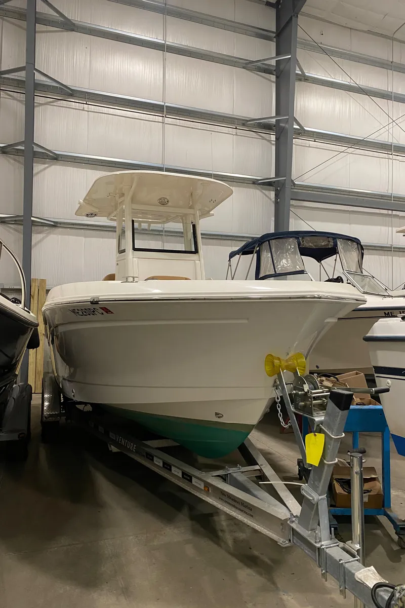 Slide: The Image of 2023 NauticStar 242L Offshore boat on trailer in indoor storage facility. - 1
