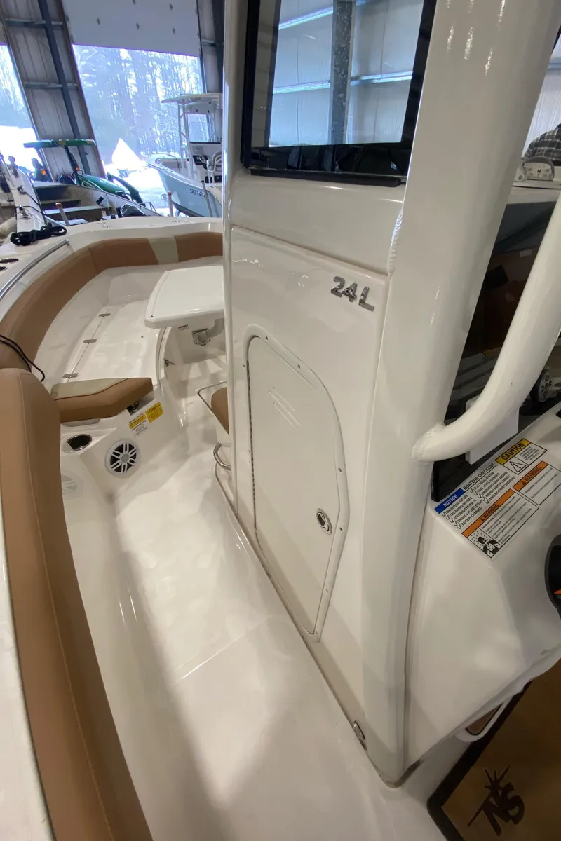 Slide: The Image of 2023 NauticStar 242L Offshore boat interior with seating and console. - 13