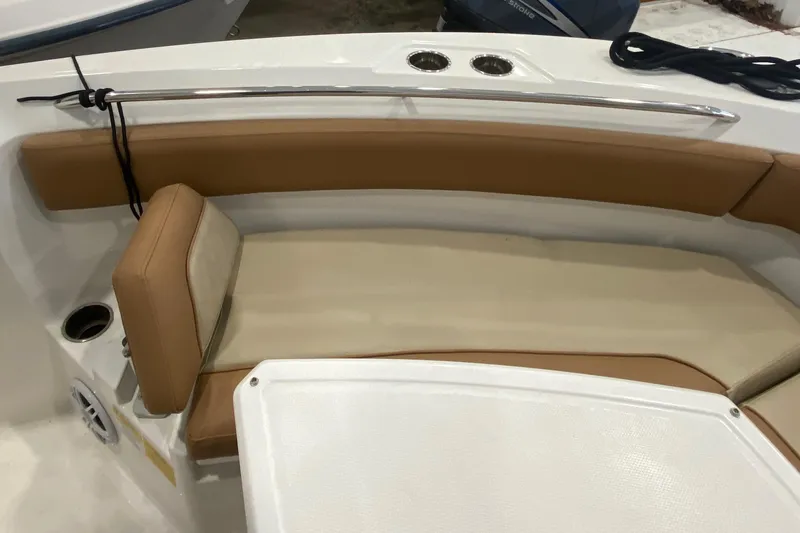 Slide: The Image of 2023 NauticStar 242L Offshore boat interior with tan seating and cup holders. - 16