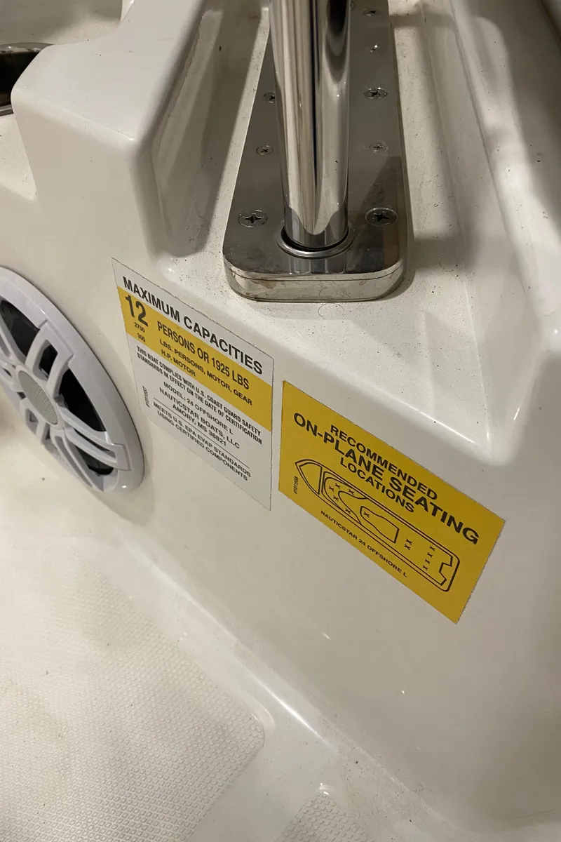 Slide: The Image of 2023 NauticStar 242L Offshore boat interior with capacity and seating labels. - 18