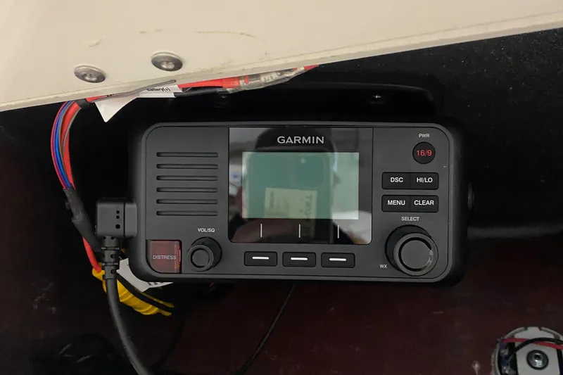 Slide: The Image of Garmin marine radio on 2023 NauticStar 242L Offshore boat dashboard. - 19
