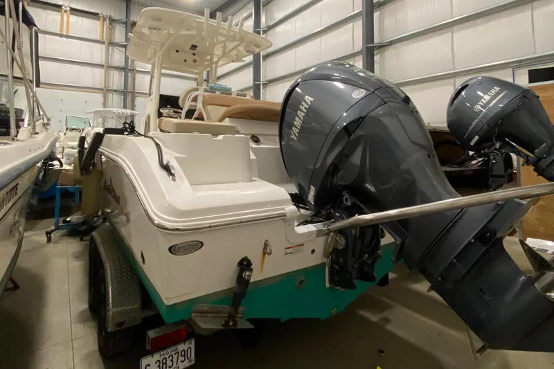 Slide: The Image of 2023 NauticStar 242L Offshore boat with Yamaha engines in storage facility. - 3