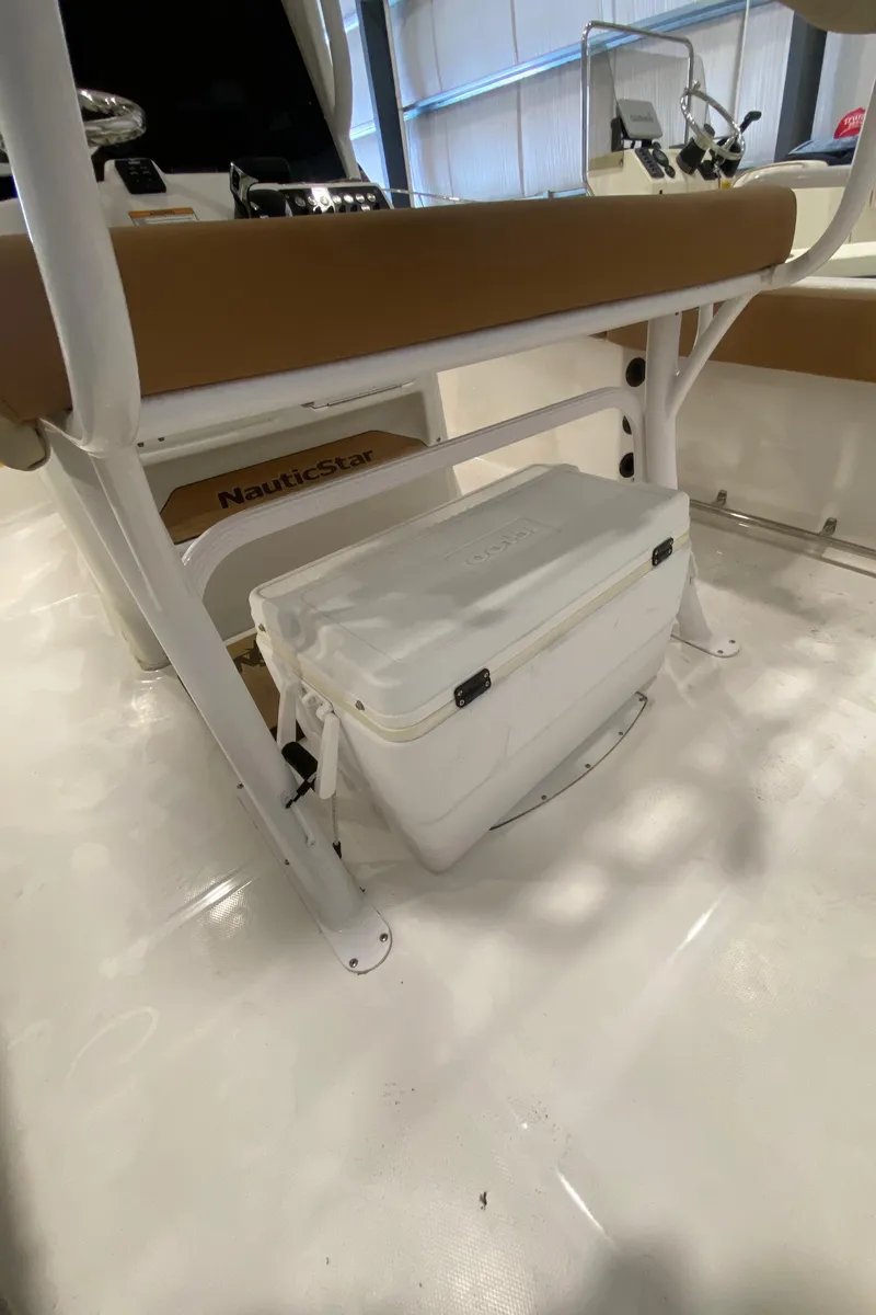 Slide: The Image of 2023 NauticStar 242L Offshore boat interior with seating and storage compartment. - 6