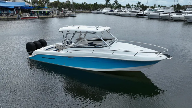 Slide: The Image of 2008 Hydra-Sports Vector 3300 VX boat docked in a marina with other vessels. - 1