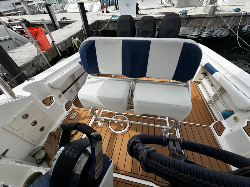 Slide: The Image of 2008 Hydra-Sports Vector 3300 VX boat interior with seating and wooden deck at a marina. - 10