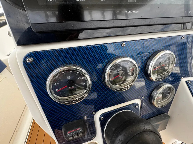 Slide: The Image of Dashboard of 2008 Hydra-Sports Vector 3300 VX with gauges and Garmin display. - 16