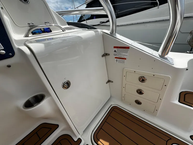 Slide: The Image of 2008 Hydra-Sports Vector 3300 VX boat interior with storage compartments and stainless steel railing. - 20