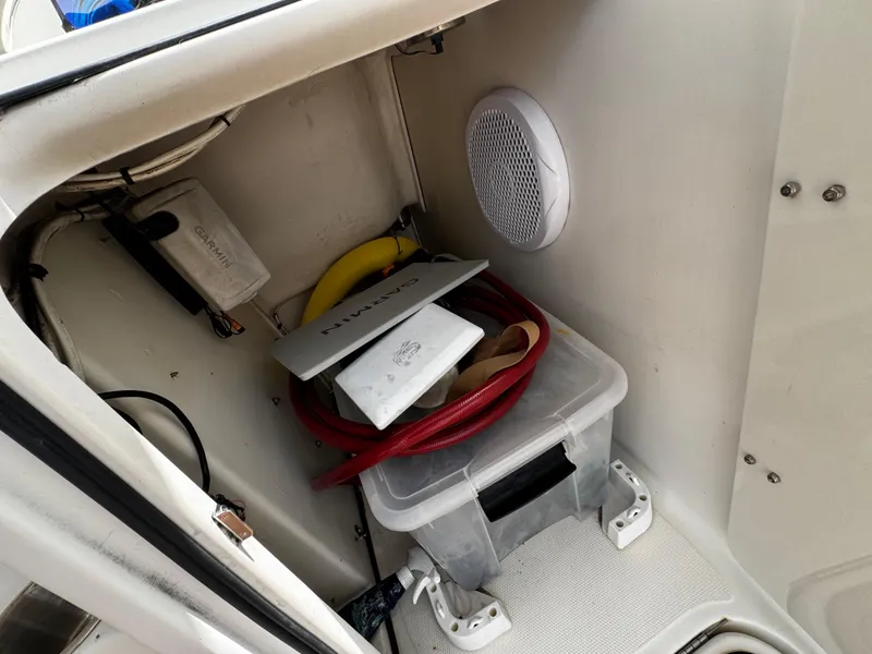 Slide: The Image of Storage compartment in a 2008 Hydra-Sports Vector 3300 VX boat with various items. - 21
