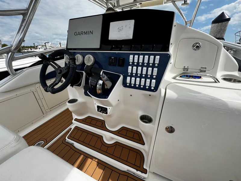 Slide: The Image of 2008 Hydra-Sports Vector 3300 VX helm with Garmin navigation, modern controls, and wood-style flooring. - 23
