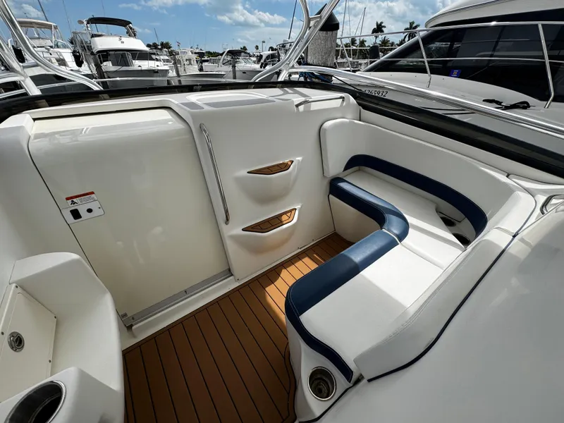 Slide: The Image of 2008 Hydra-Sports Vector 3300 VX boat interior with white and blue seating, docked at marina. - 24