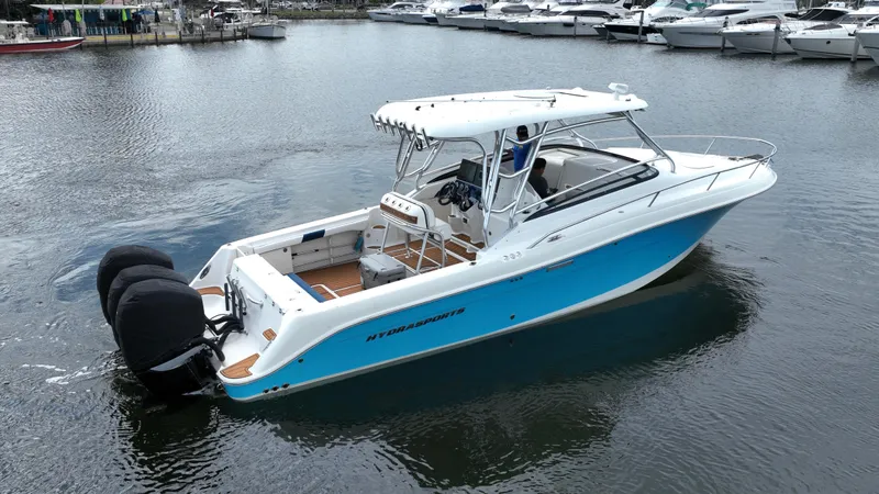 Slide: The Image of 2008 Hydra-Sports Vector 3300 VX boat with dual engines, docked in a marina. - 3