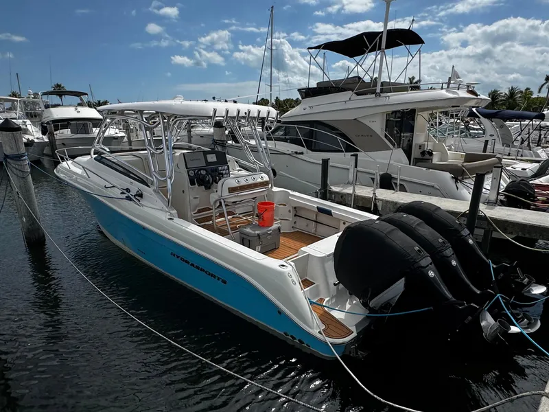Slide: The Image of 2008 Hydra-Sports Vector 3300 VX boat docked at marina, featuring dual outboard engines. - 40