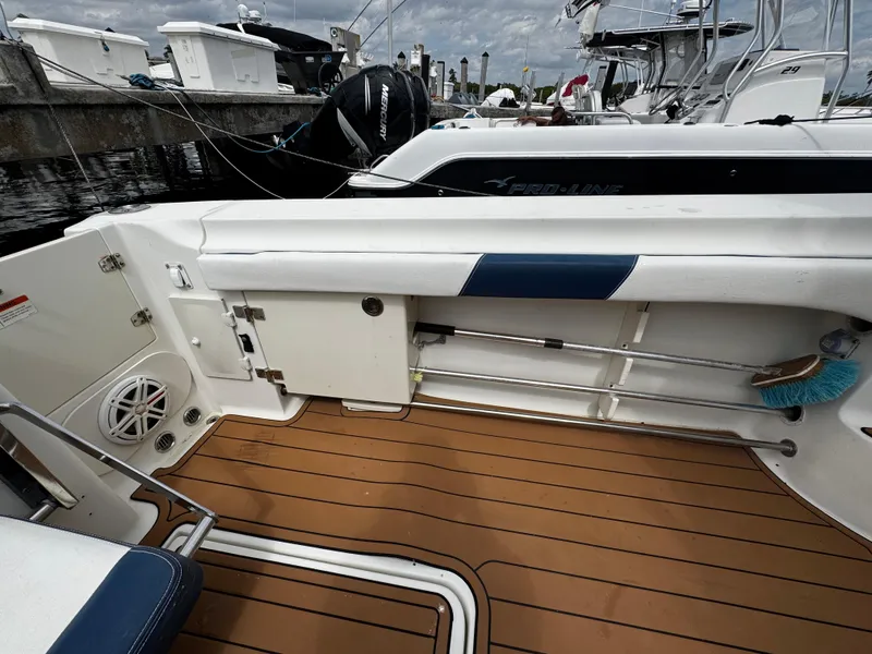Slide: The Image of 2008 Hydra-Sports Vector 3300 VX boat interior with teak flooring and storage compartments. - 7