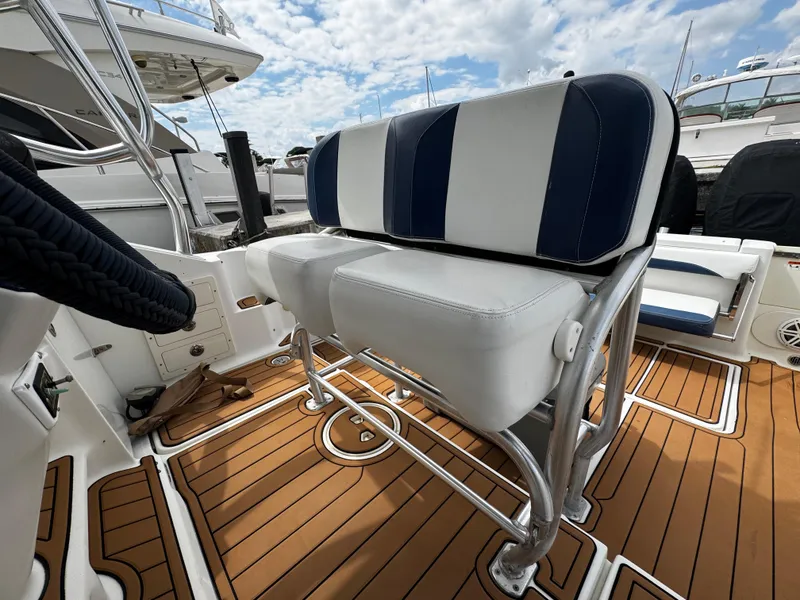 Slide: The Image of 2008 Hydra-Sports Vector 3300 VX boat seating on teak deck, marina background. - 9