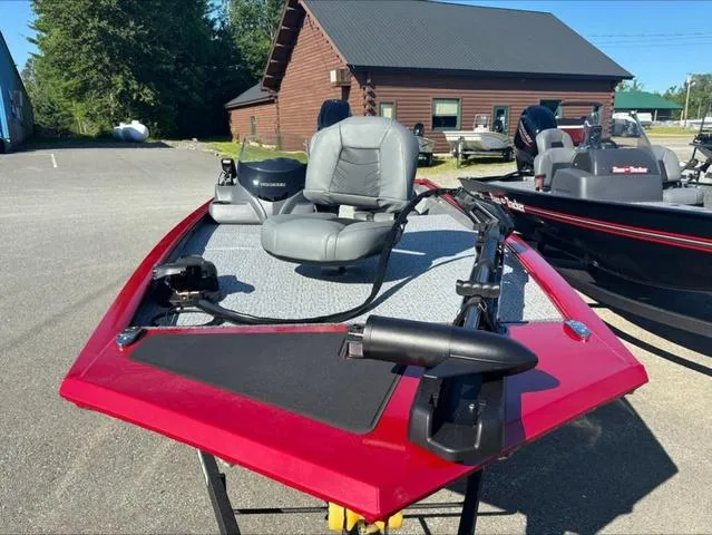 Slide: The Image of 2024 Tracker Pro 170 boat with red exterior, gray seating, and fishing equipment. - 3